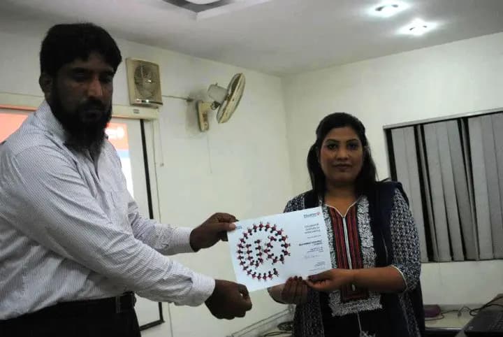 A student receives their certificate through Study Bridge support